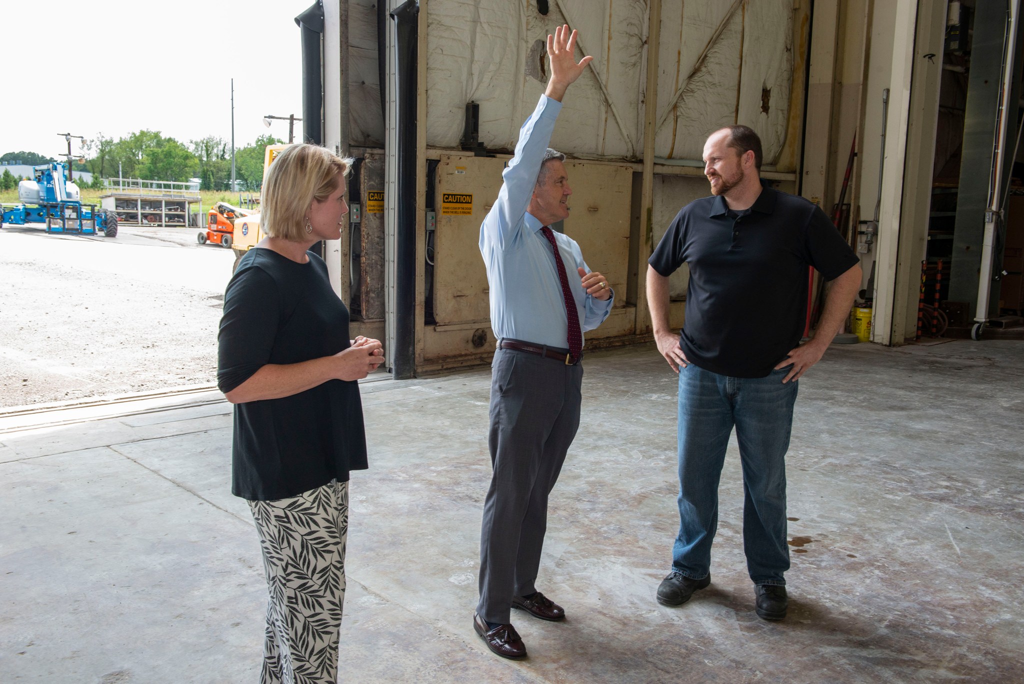 Kennedy Space Center Director Robert Cabana, center, receives an update on SLS hardware from Heather Haney, left, and Mark White