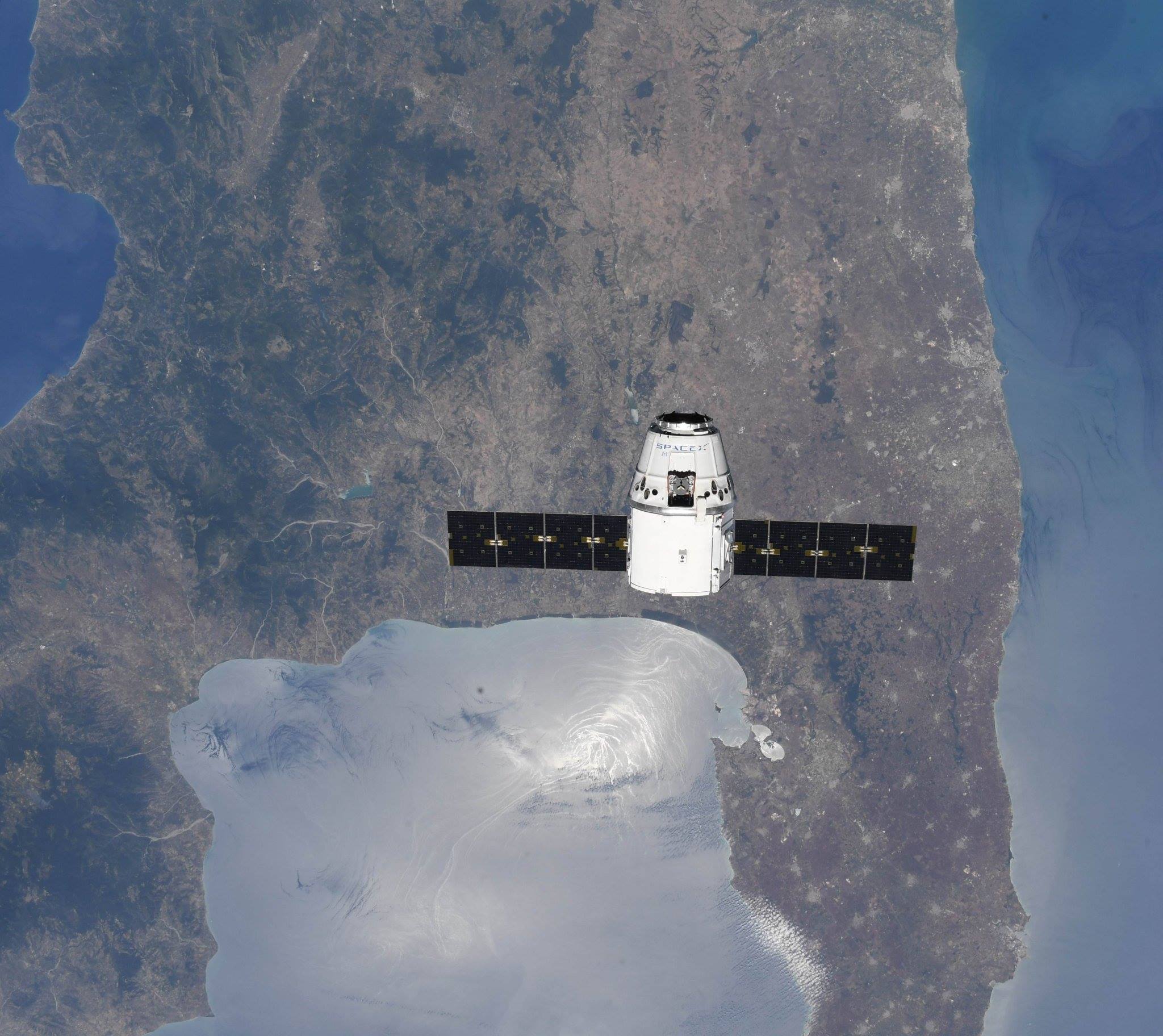 Here, the Dragon capsule flies over the boot of Italy. 