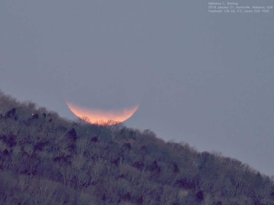 The Moon is seen here during the January 2018 lunar eclipse, setting in the western horizon, not yet in totality.