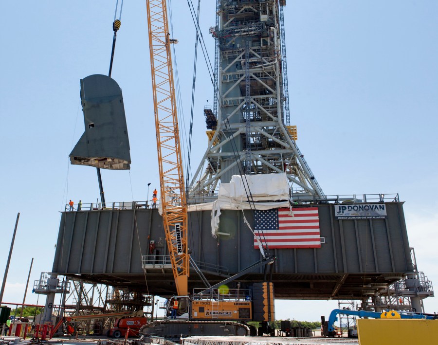 The first of two Tail Service Mast Umbilicals is lifted for installation on the mobile launcher July 12, 2018, at NASA's Kennedy Space Center in Florida.