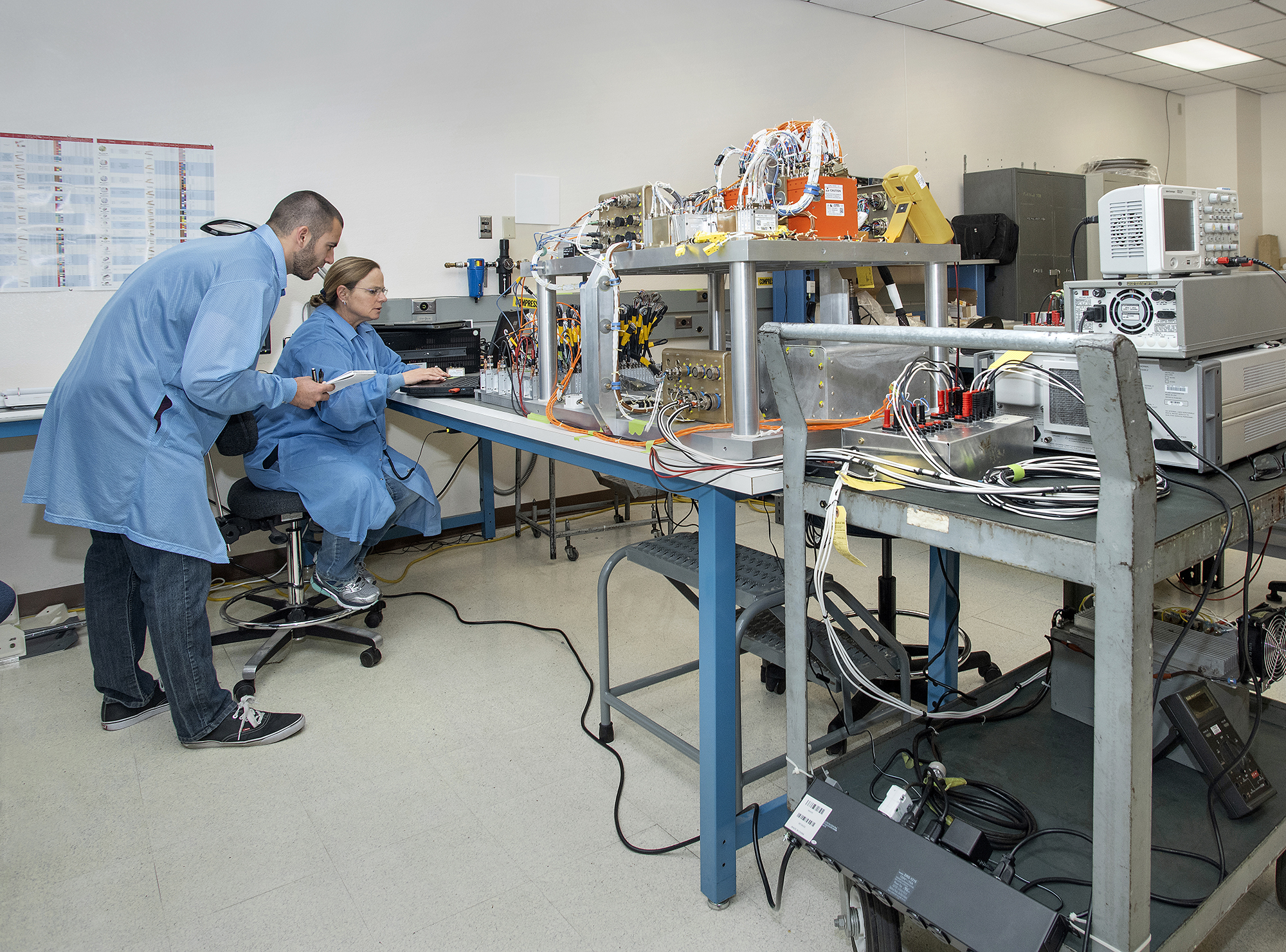 April Torres and Jeffery Sutherland complete a systems and functional check on the master data acquisition system for Orion.