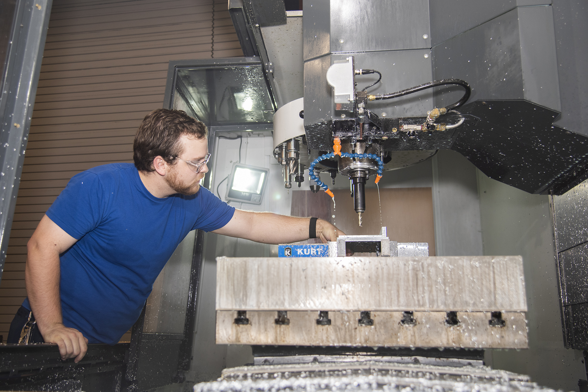 R.J. Smith mills a plate for the backup data acquisition system for the Orion Ascent Abort 2 crew module at AFRC.