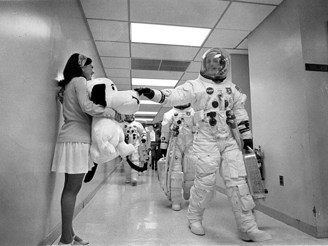 Apollo 10 Commander Tom Stafford gives a Snoopy plush toy a pat on the nose on launch day.