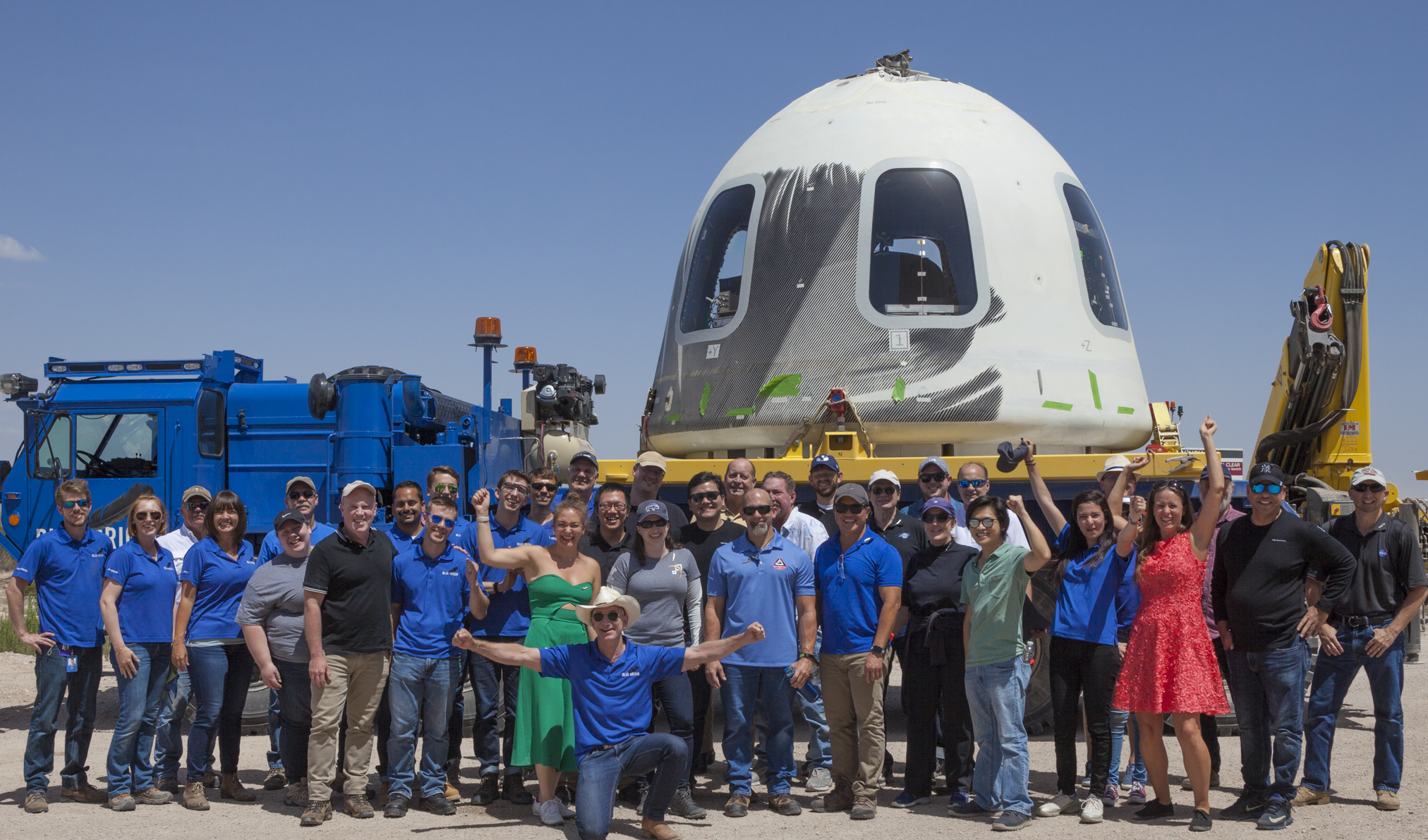 Research teams from NASA’s Flight Opportunities program pose in front of the Blue Origin capsule.