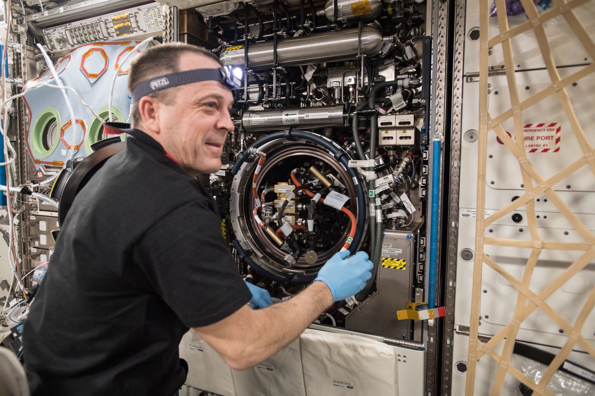 NASA Expedition 56 astronaut Ricky Arnold is pictured here troubleshooting the Combustion Integrated Rack aboard the ISS.