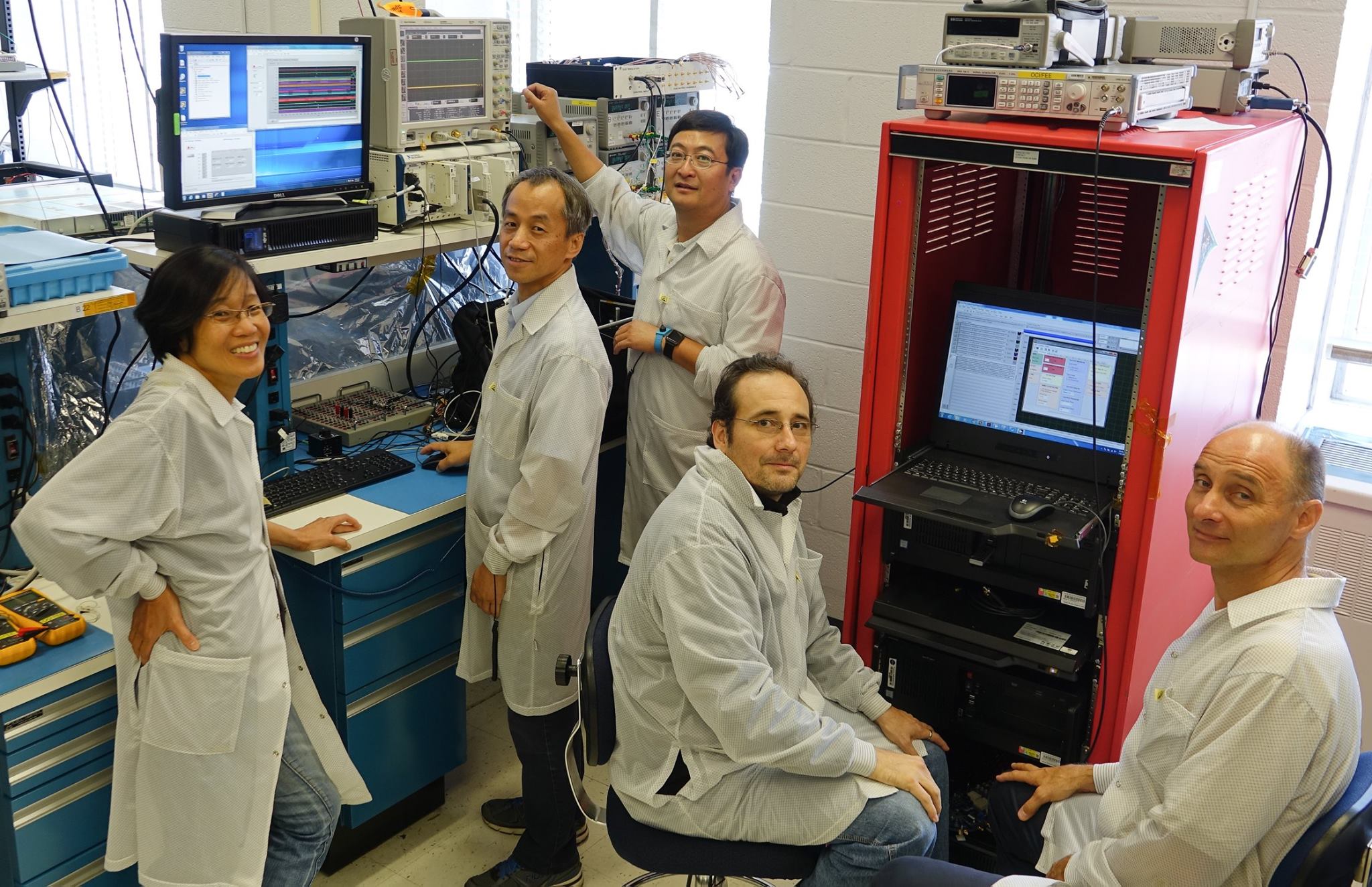 Group photo of PACE team, five people in lab coats, four men and one woman 
