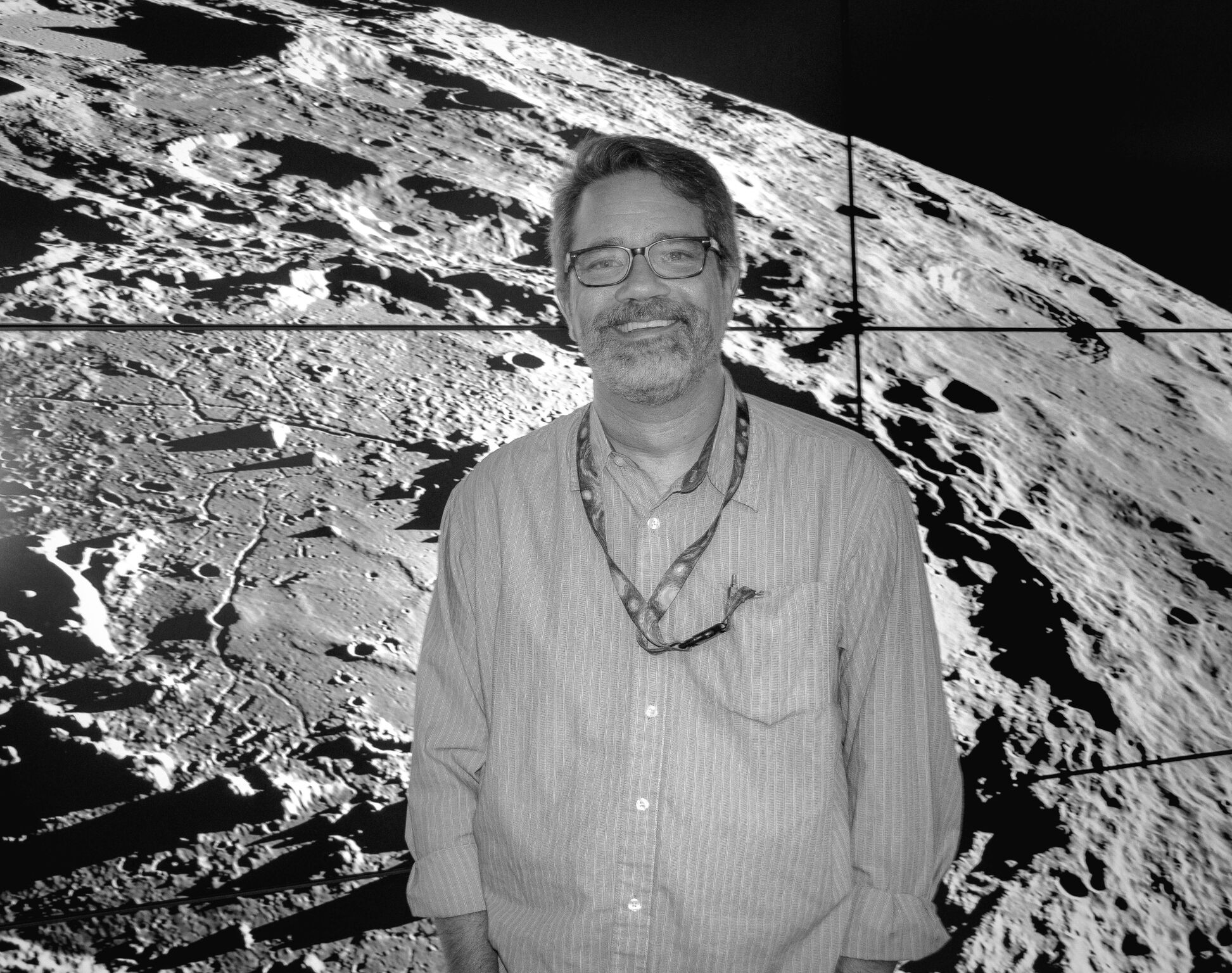 black and white image of man in front of moon image
