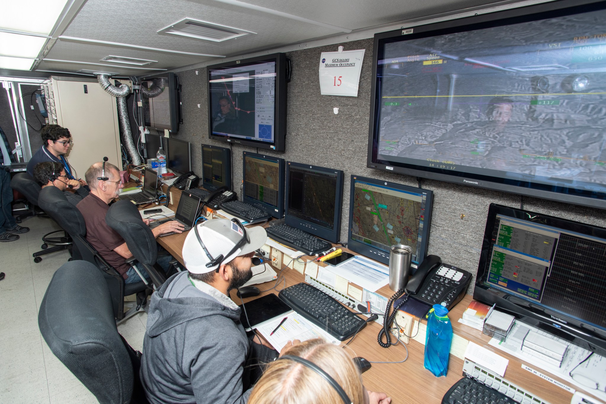 Engineers at NASA‘s Armstrong Flight Research Center sit in a mission control room to monitor the remotely-piloted Ikhana