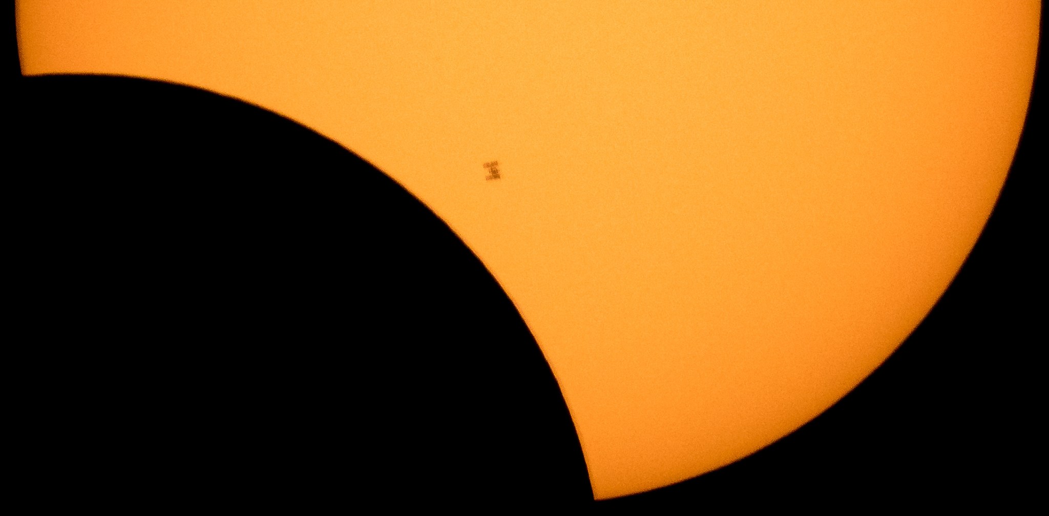 The International Space Station, with a crew of six onboard, is seen in silhouette as it transits the Sun 