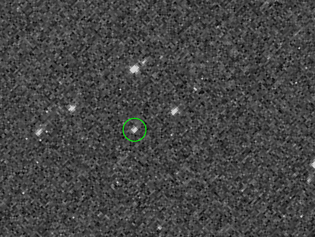 grainy image with a moving bright spot in a green circle