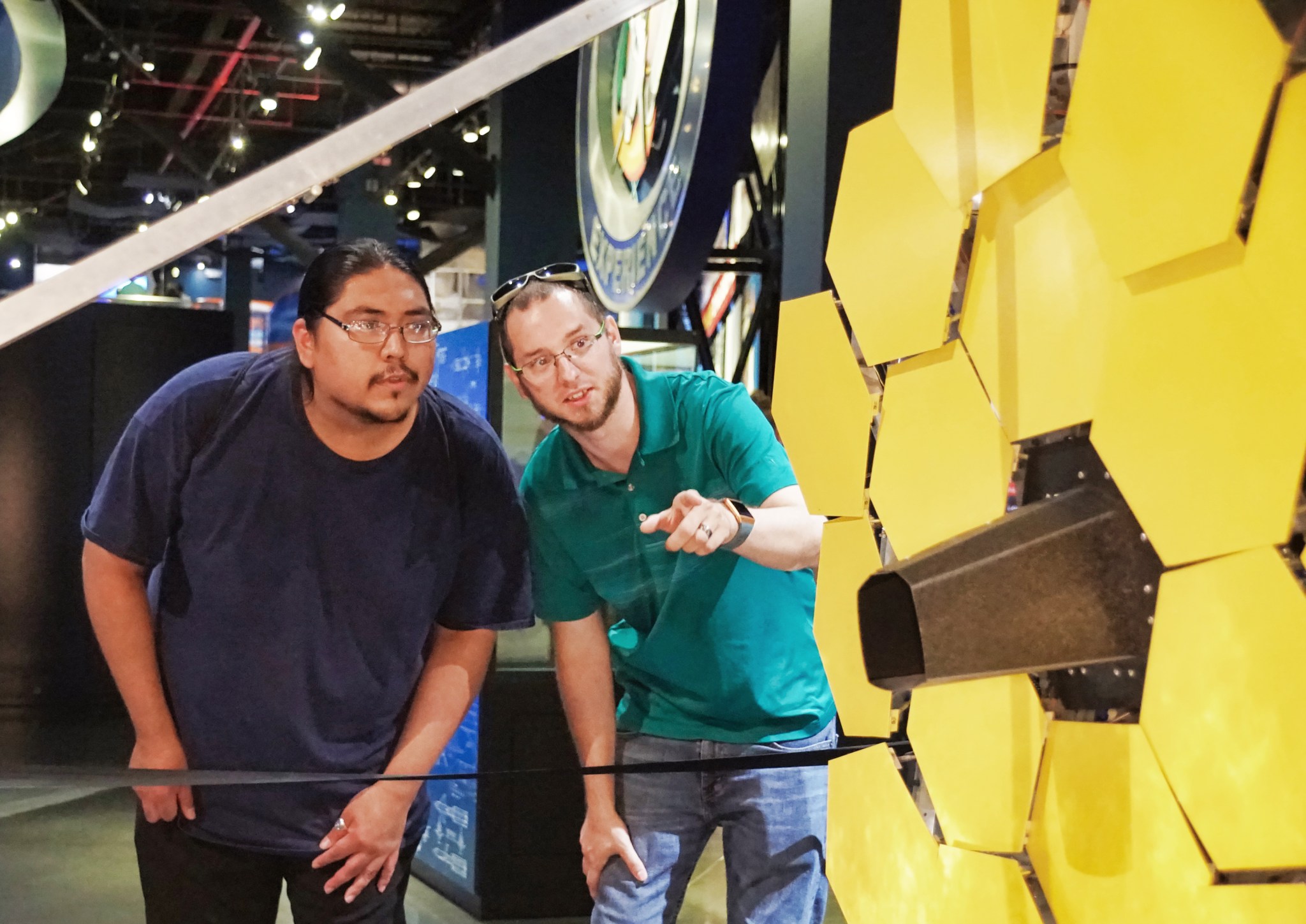 Troy Bearcomesout, Steve Vought examine a model of the James Webb Space Telescope