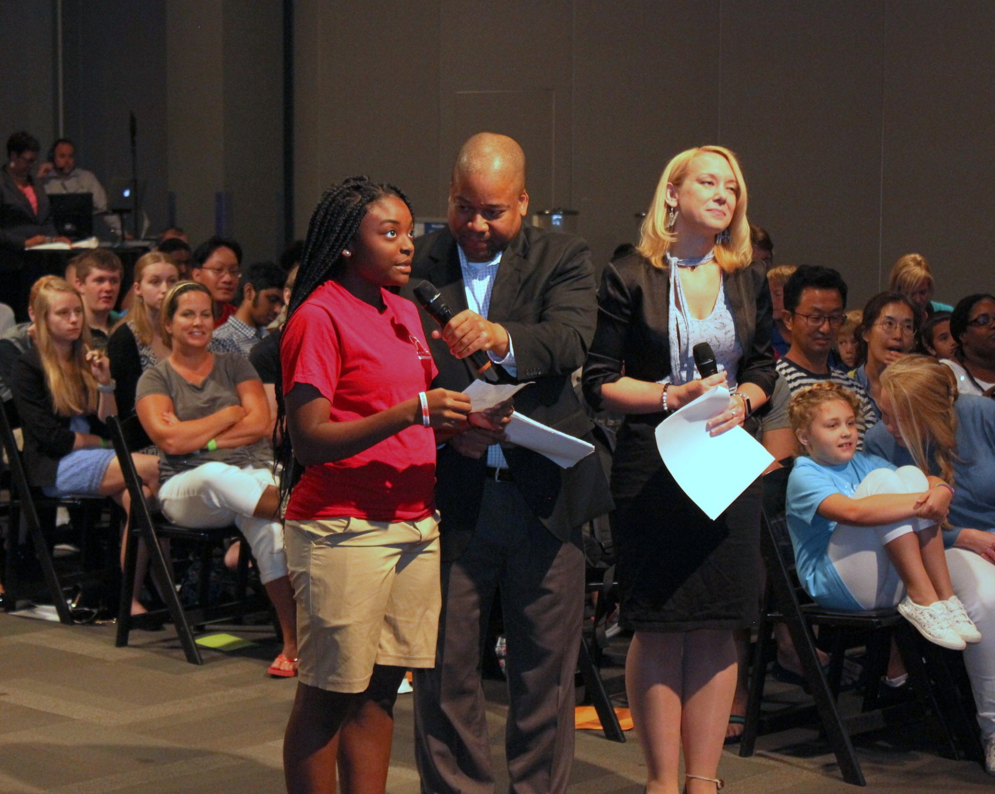 A summer camp student asks her question with help from Christian Greer (center), and Anna Green (right).