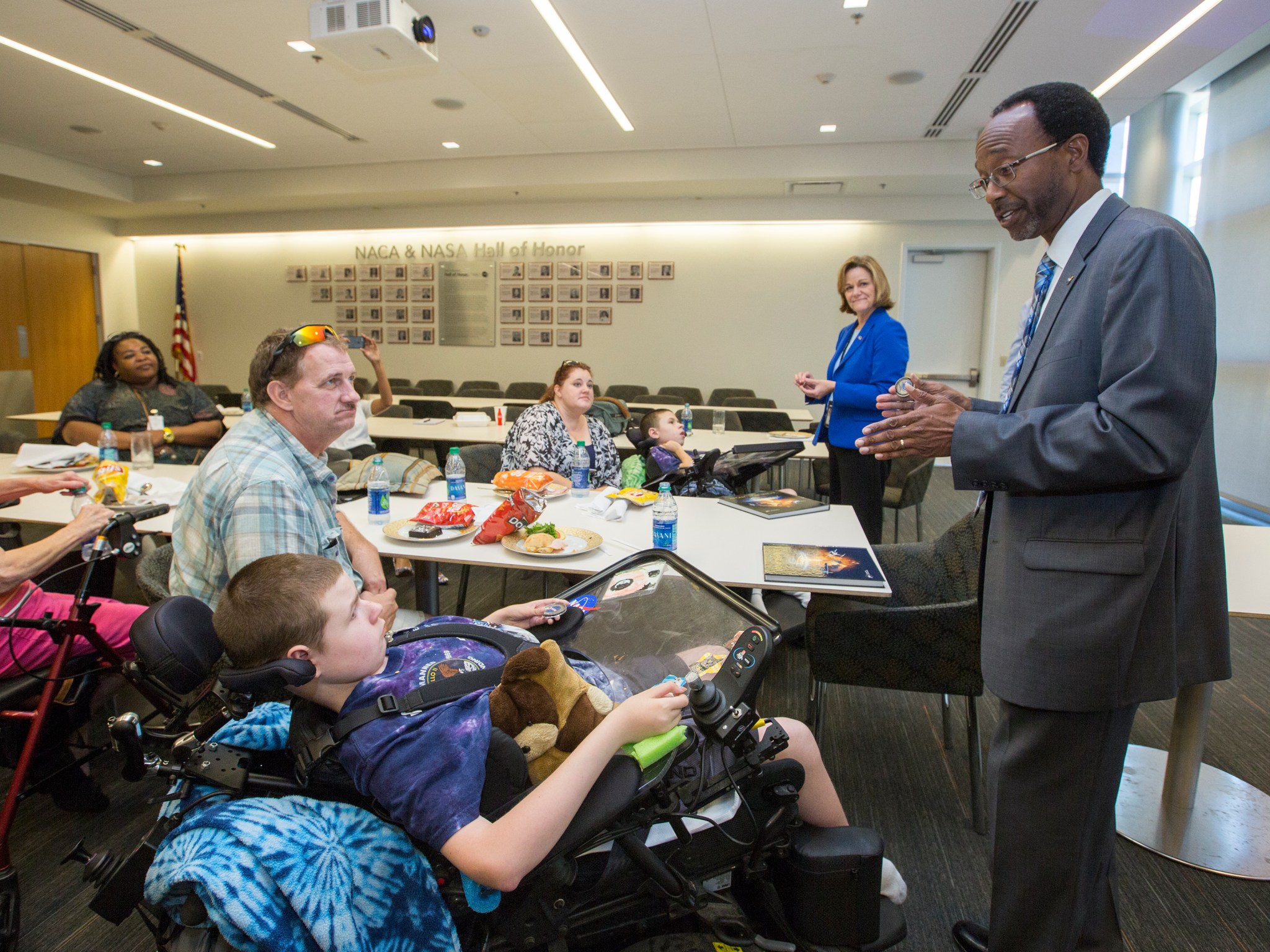 Clayton Turner presents Robbie with a coin and book.