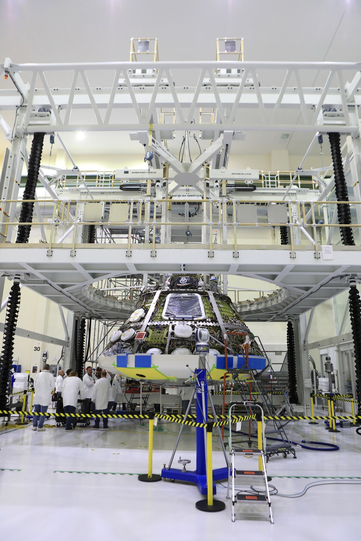 The heat shield is installed on the Orion crew module July 25, 2018, in the O&C high bay at NASA's Kennedy Space Center.