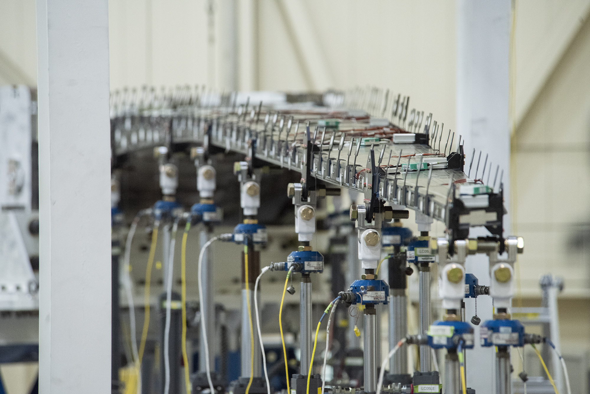 The Passive Aeroelastic Tailored wing is tested in a fixture at the NASA Armstrong Flight Research Center?s Flight Loads Lab.
