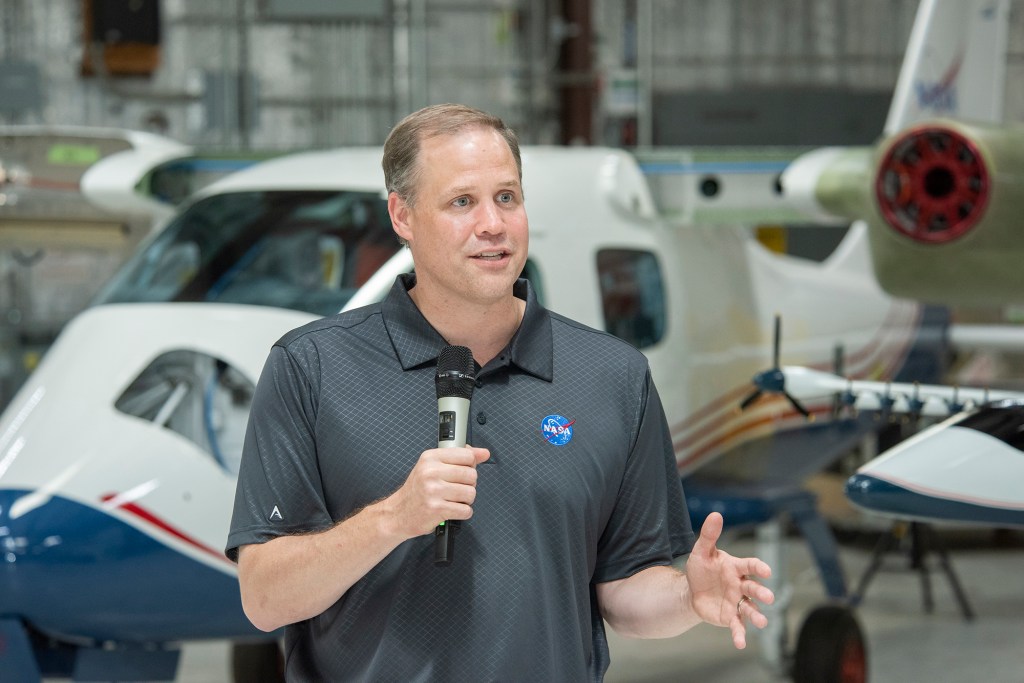 NASA Administrator Bridenstine talks to press in front of X-57.