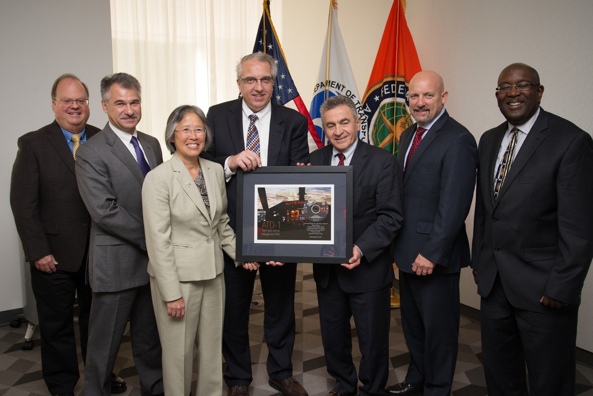 Executives from NASA, the FAA, and industry during a ceremony celebrating the tech transfer of the FlM software from NASA to FAA