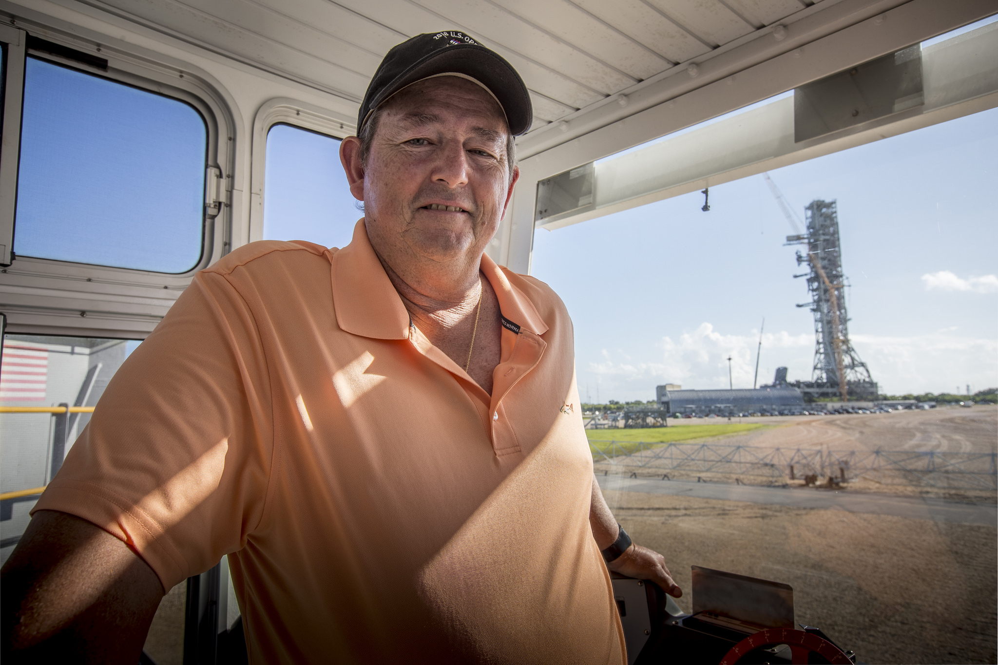Bob Myers, a mechanical systems engineer sits inside the operatoar cab of crawler-transporter 2 at Kennedy Space Center.
