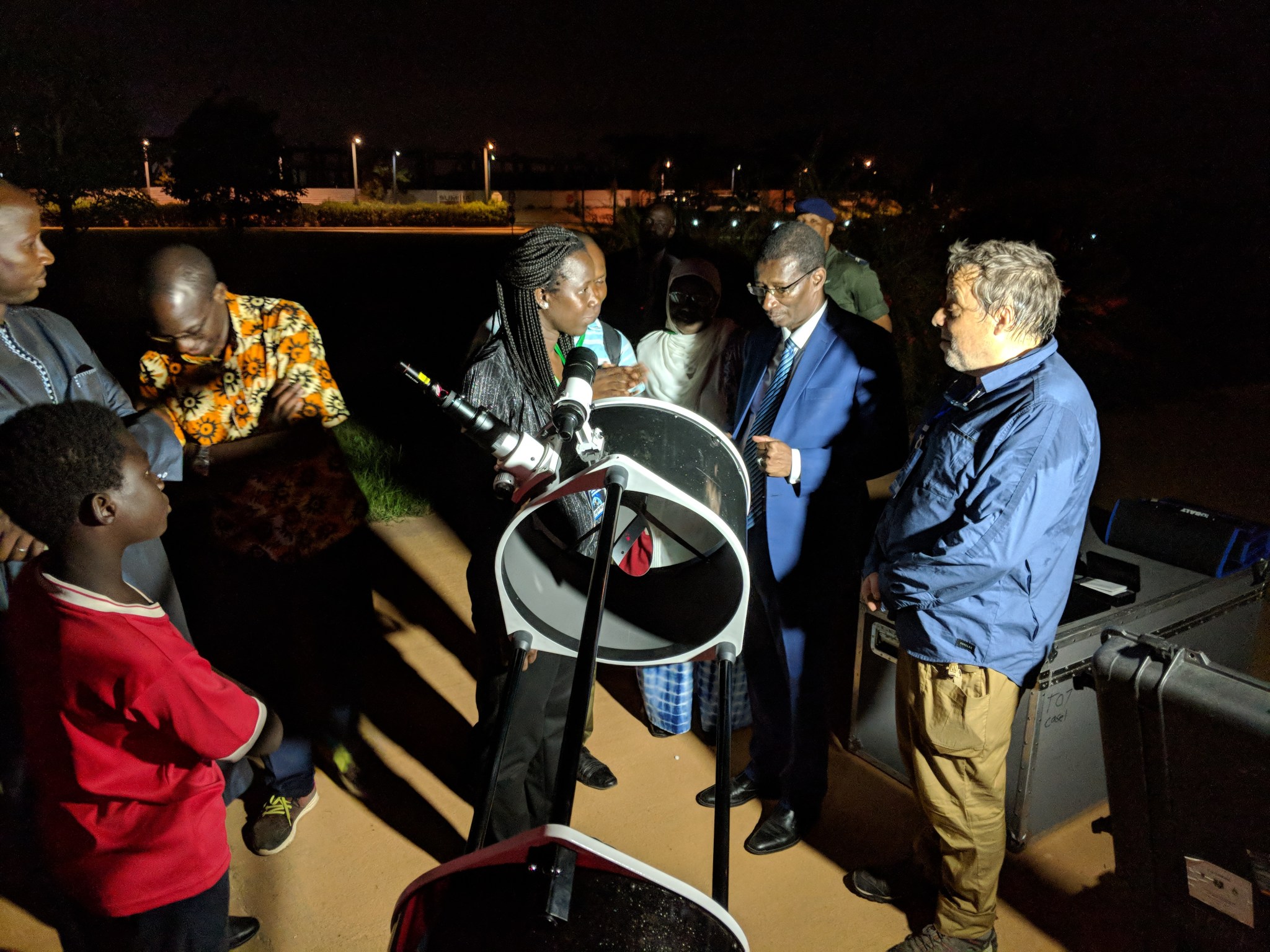 Occultation team members show their telescope to he Sénégalese Minister of Higher Education, Research, and Innovation