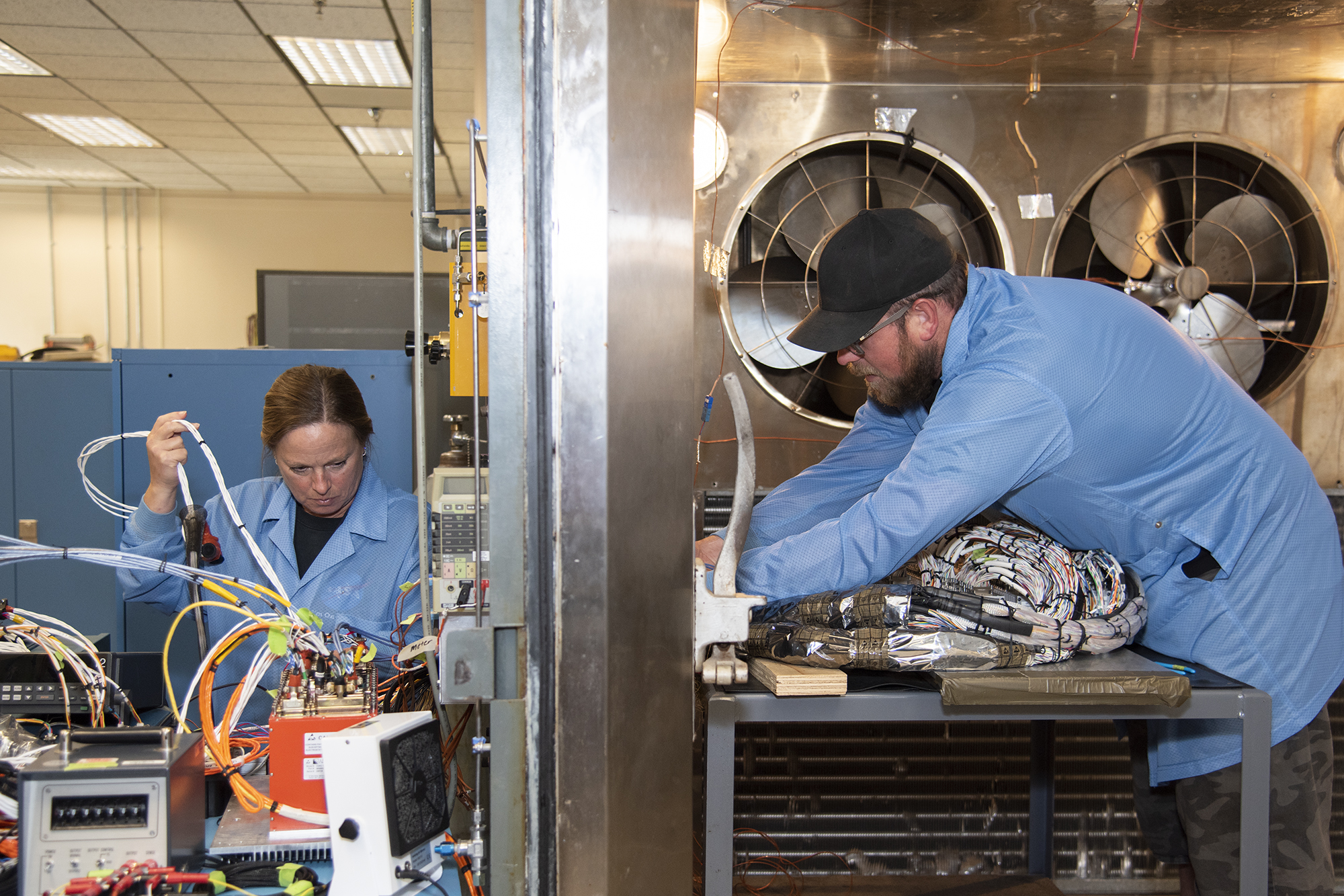 April Torres and Kyle Dauk set up for a thermal test of components in the Environmental Laboratory at NASA’s AFRC.
