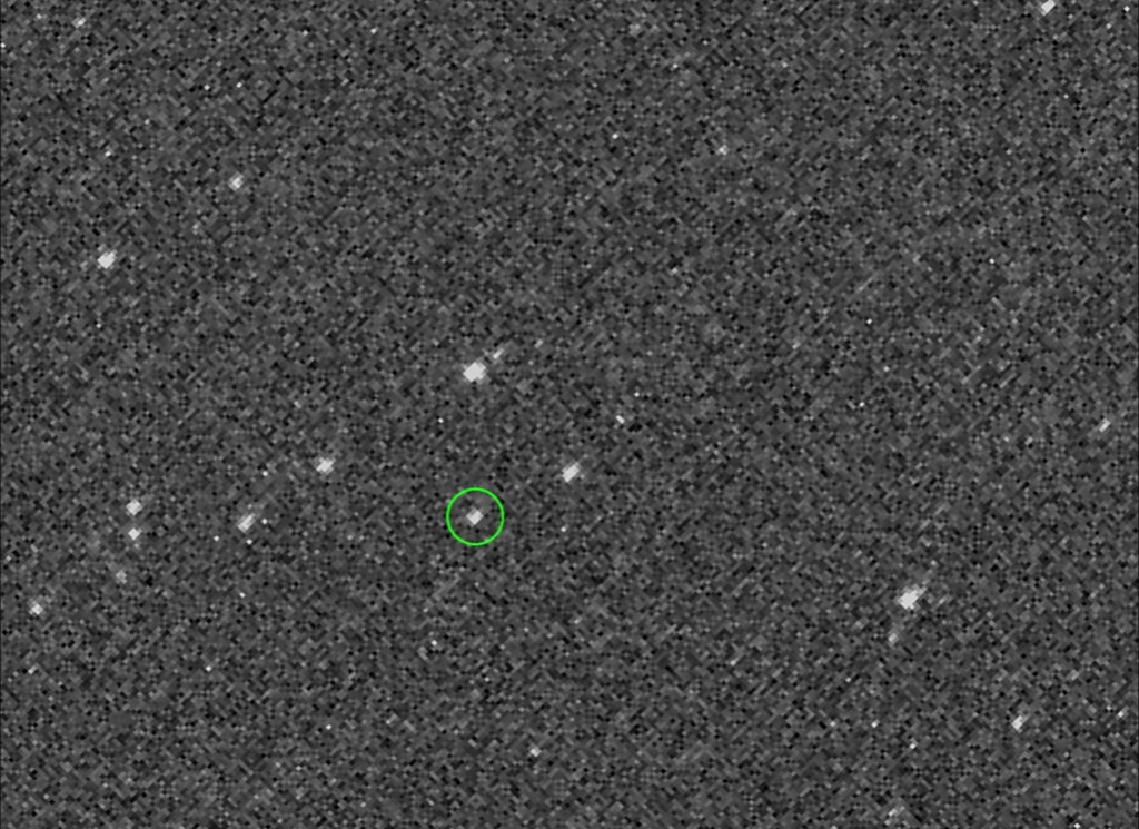 Very pixelated image of asteroids with Asteroid Bennu circled in green.