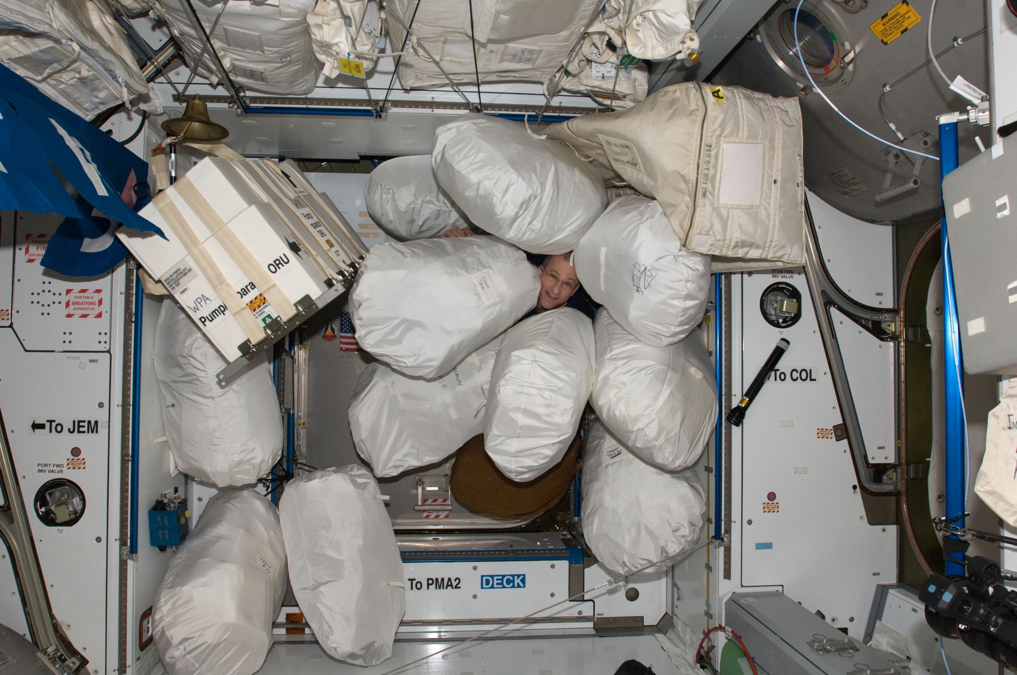 NASA astronaut Don Pettit, Expedition 30 flight engineer, pictured among stowage bags in the Harmony node of the space station.