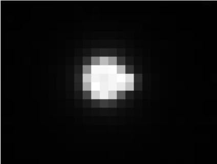 Earth and Moon, as seen by Parker Solar Probe. The two look like one pixelated blob in this image. Earth is the bulk of white pixels against a black screen with a tiny bulge of pixels extending to the right. This bulge is the Moon. The image looks like an 8-bit illustration.