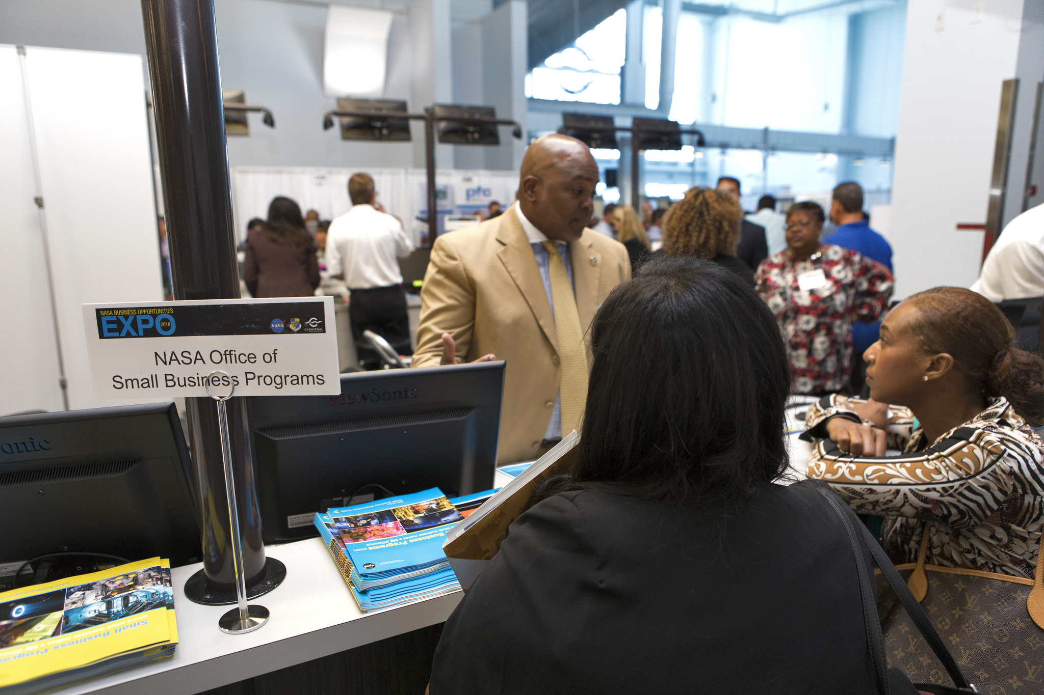Attendees talks to a representative from the NASA Office of Small Business Programs.