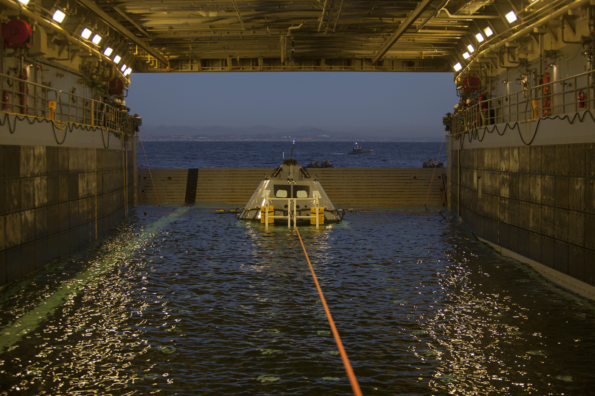 The Orion test article sits inside the well deck of the USS Anchorage after a successful recovery test in January 2018. 