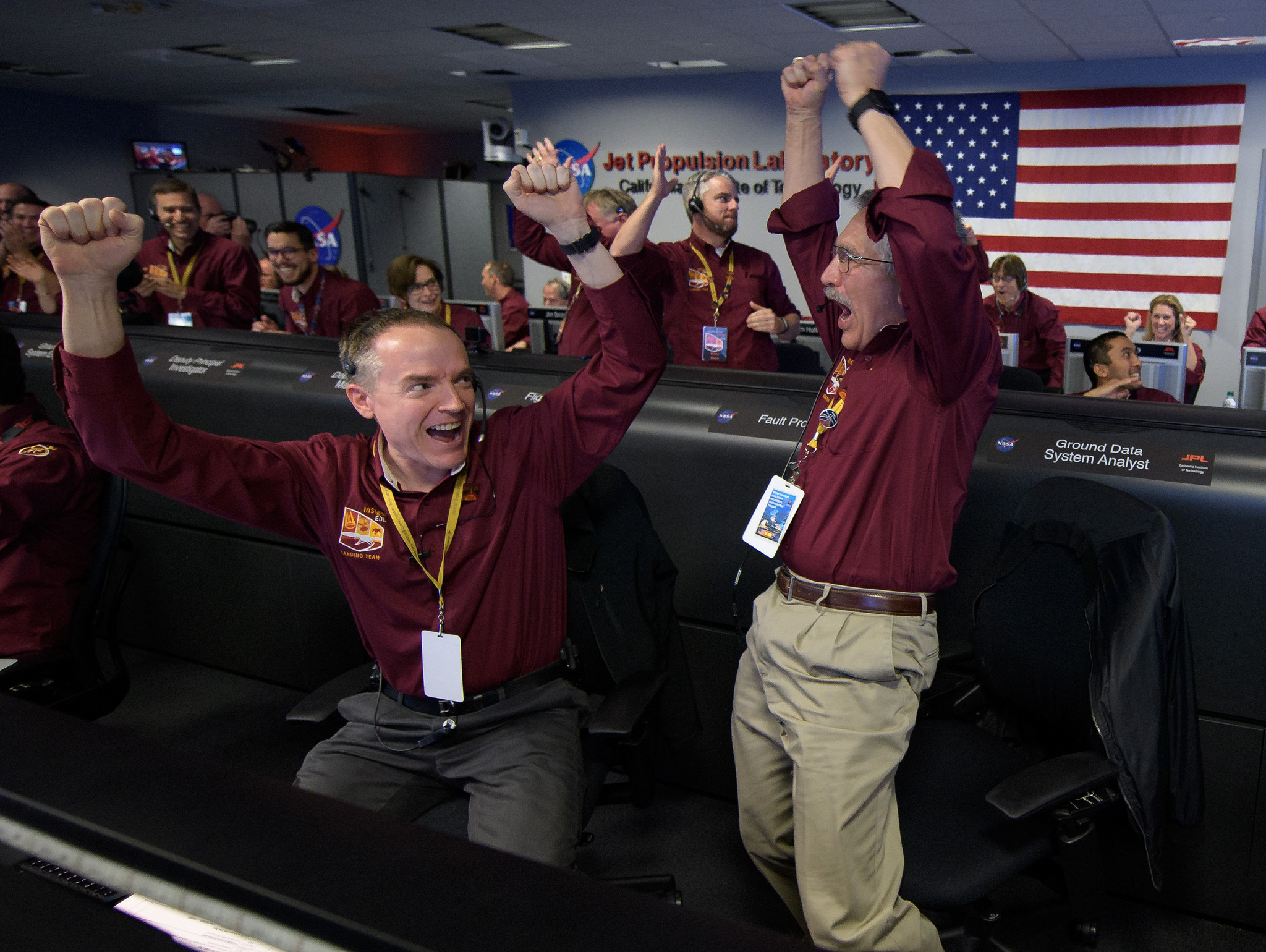 Mars InSight team members Kris Bruvold, left, and Sandy Krasner react after receiving confirmation that InSight landed