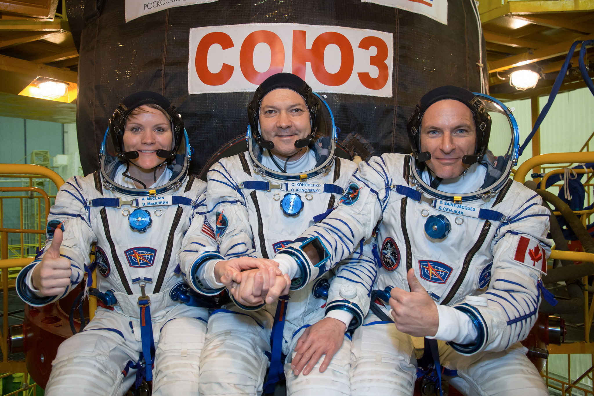 In the Integration Facility at the Baikonur Cosmodrome in Kazakhstan, Expedition 58 crew members Anne McClain of NASA (left),