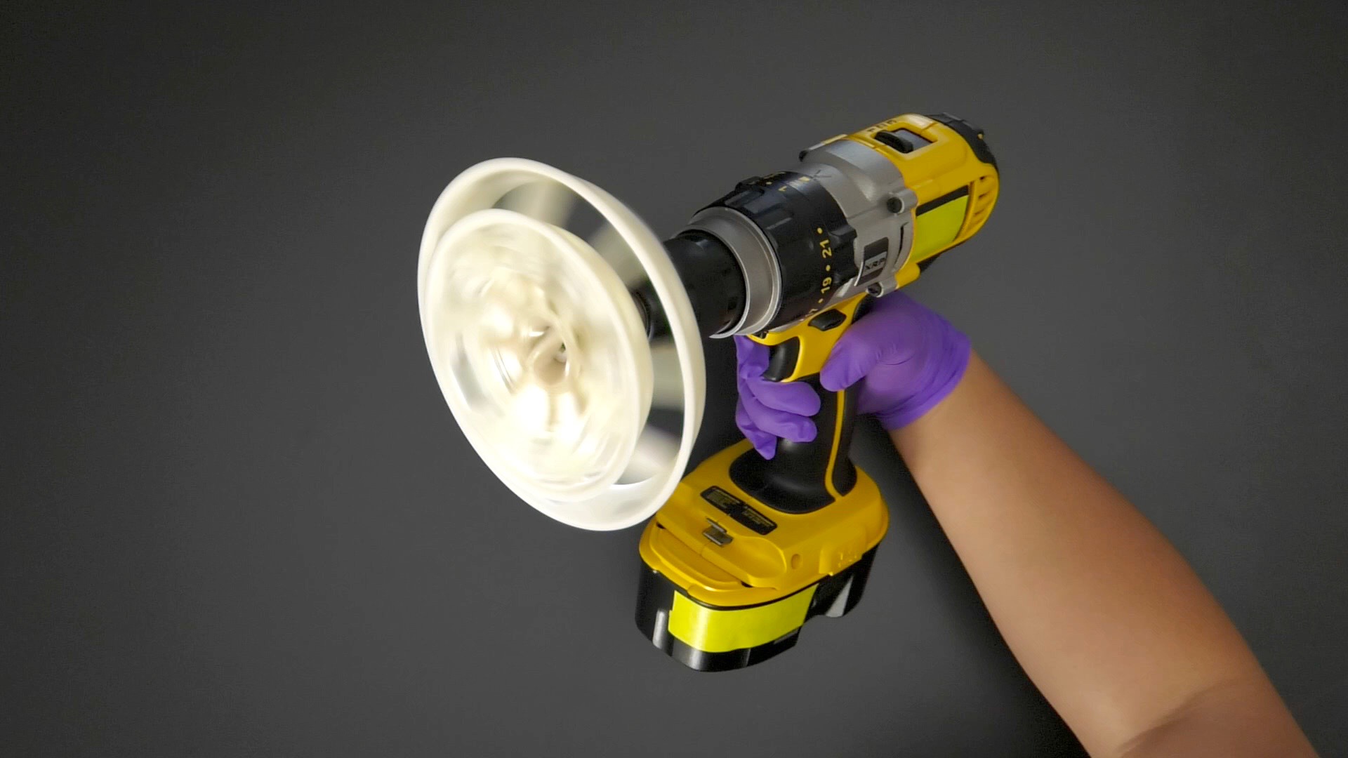 A handheld power drill is seen spinning a rotor.