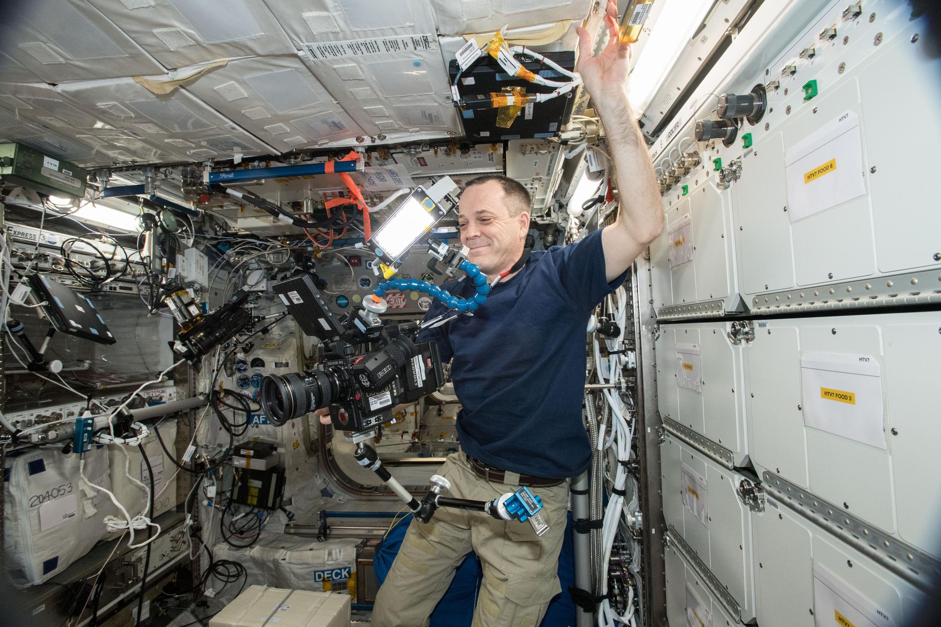 NASA astronaut Ricky Arnold does some filming on the International Space Station Oct. 3, with a Helium 8K camera.
