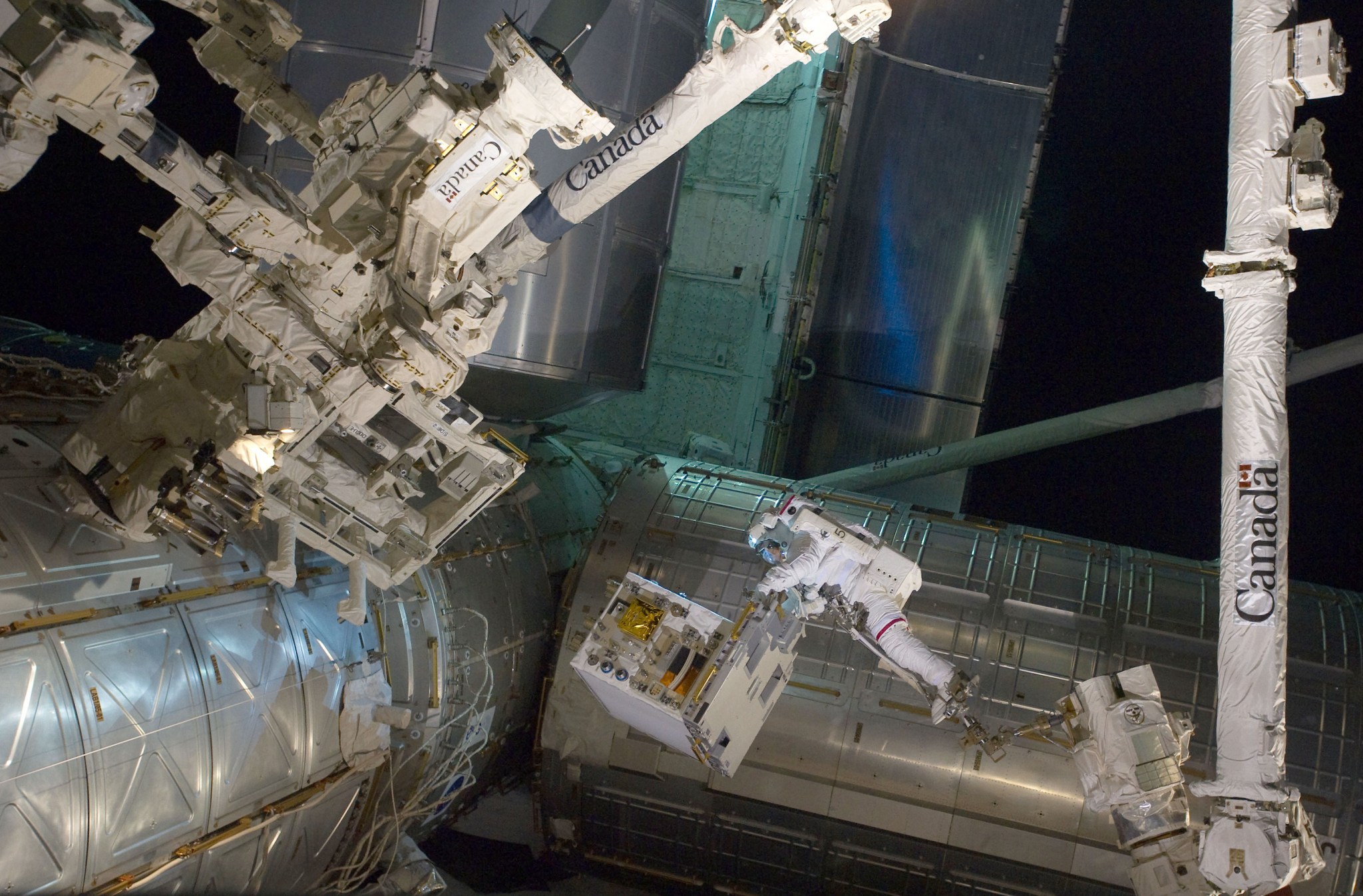 RRM module and spacewalking astronauts