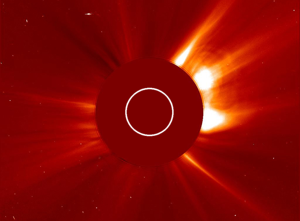 Image of solar wind, mainly red image with sun light streaking from behind a red circle with a white circle outline inside.