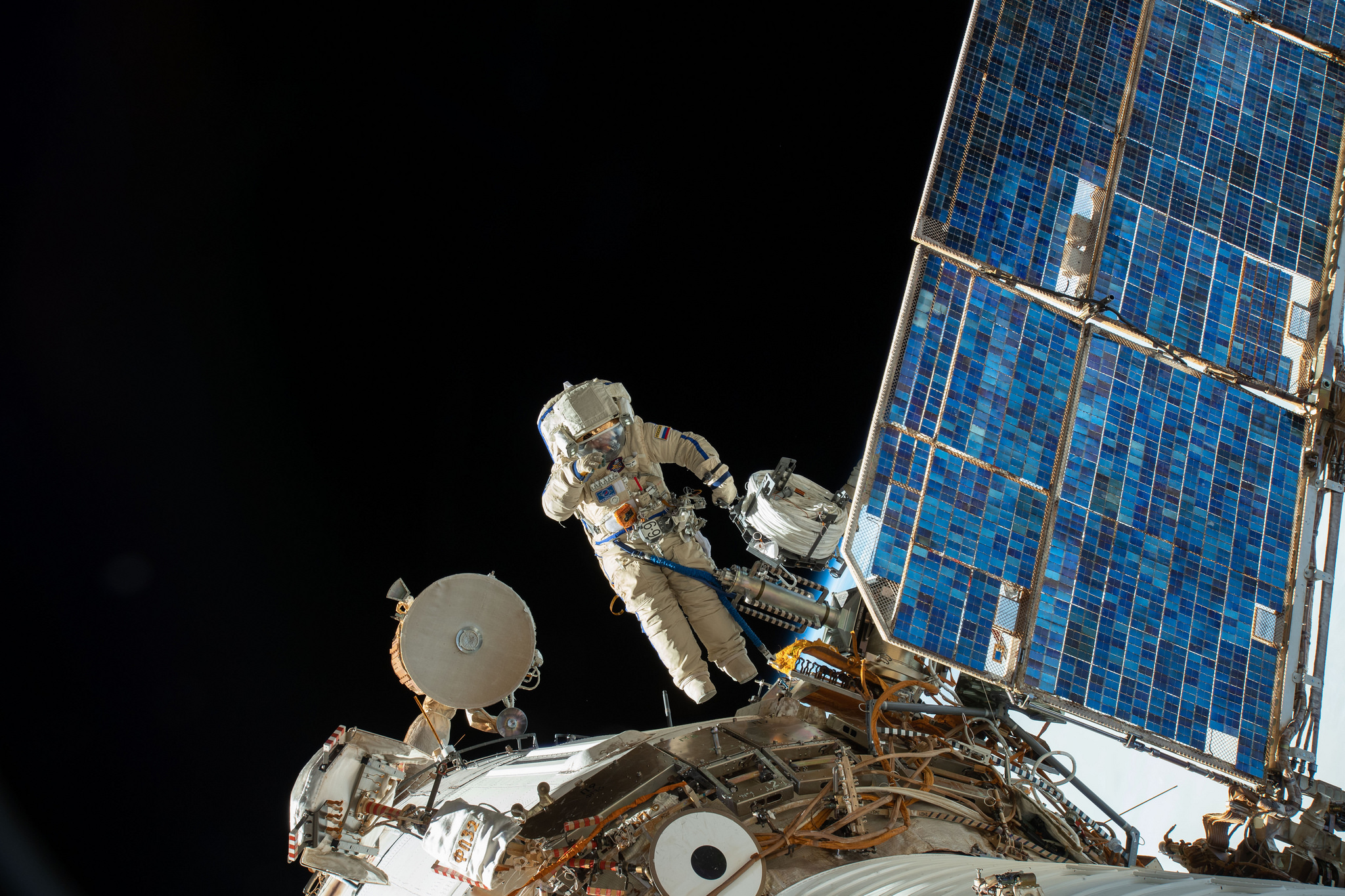 Roscosmos cosmonaut Sergey Prokopyev lays cable for the installation of the Icarus animal-tracking experiment