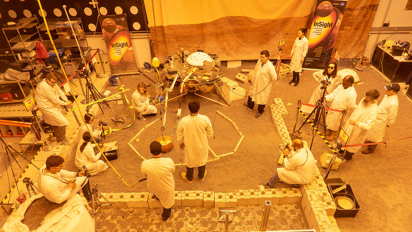 Engineers practice deploying InSight's instruments in a lab at NASA's Jet Propulsion Laboratory 