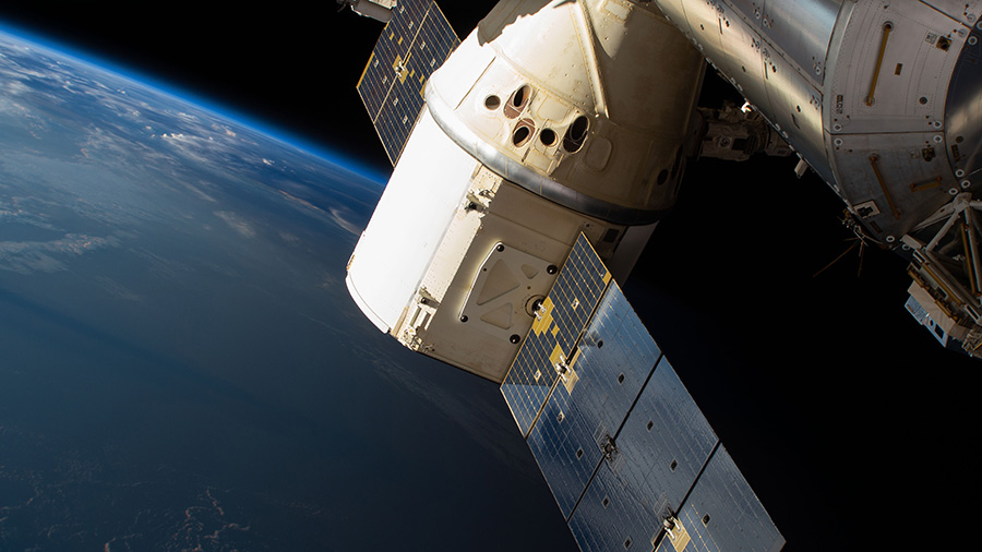 The SpaceX Dragon cargo craft is pictured attached to the International Space Station's Harmony module