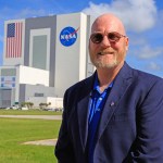 Kirk Lougheed in front of NASA's Vehicle Assembly Building