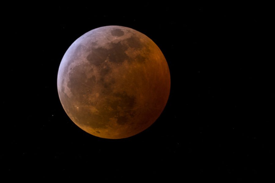 A total lunar eclipse accompanied the first in a trilogy of supermoons in 2019.