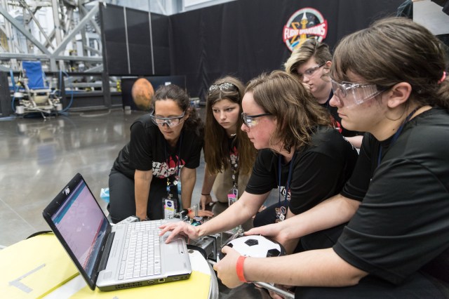 A group of students work on a laptop for NASA App Development Challenge