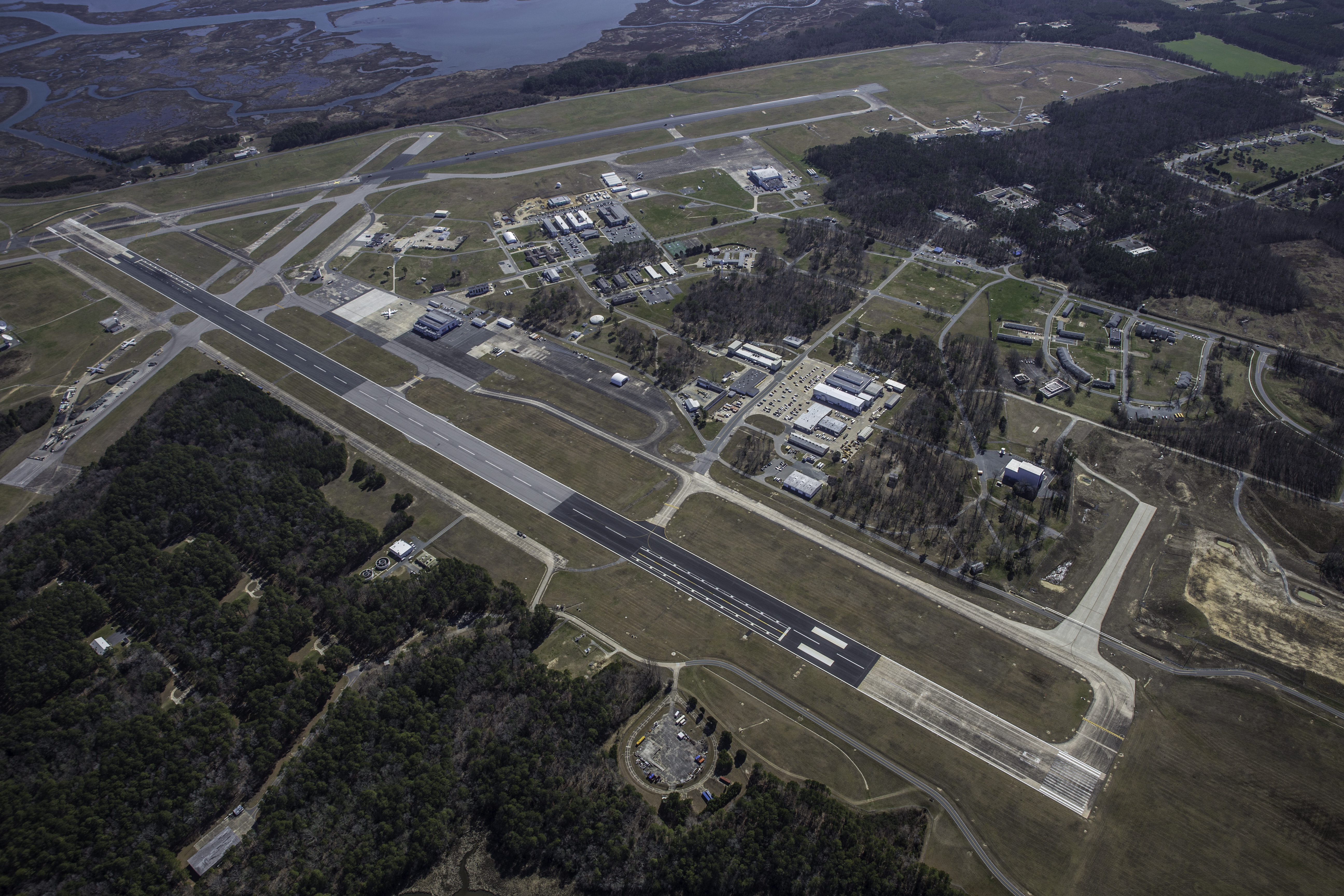 Aerial image of NASA's Wallops Flight Facility main base, with two long air strips with buildings surrounding it.