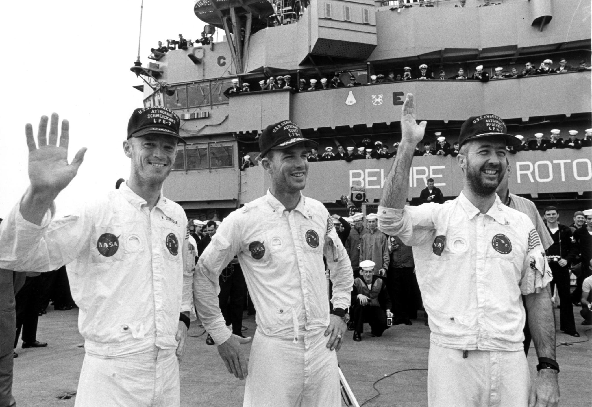 Russell Schweickart, David R. Scott and James McDivitt, wave to well-wishers aboard the recovery ship at completion of Apollo 9.