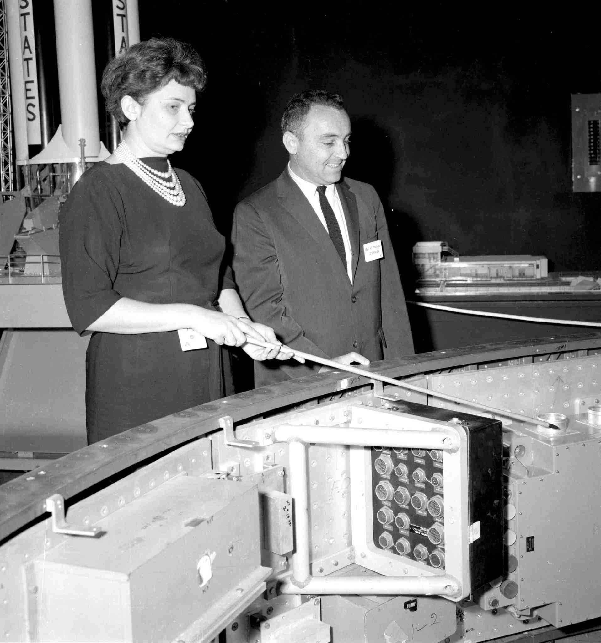 Evelyn Falkowski showing Israel Colonel Amos Horev a mockup of the Saturn I Instrument Unit in the Space Orientation Center.