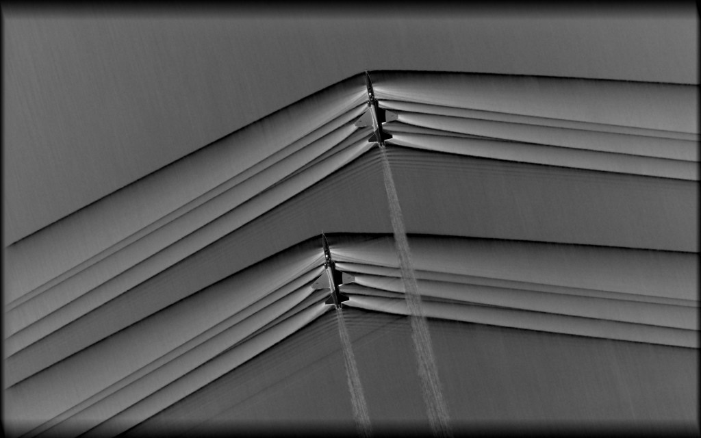 A pair of T-38 aircraft creating shockwaves during supersonic flight.