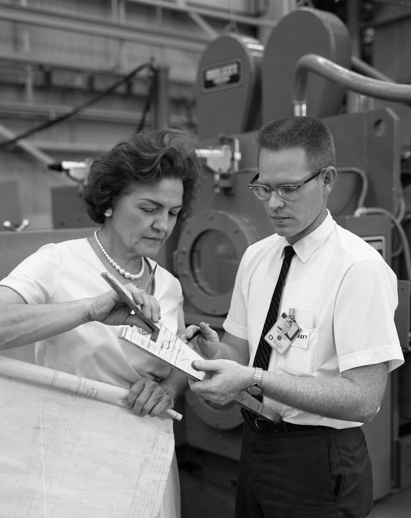 Margaret W. ‘Hap’ Brennecke reviews blueprints with Ernest Bayless in the Manufacturing and Engineering Laboratory.