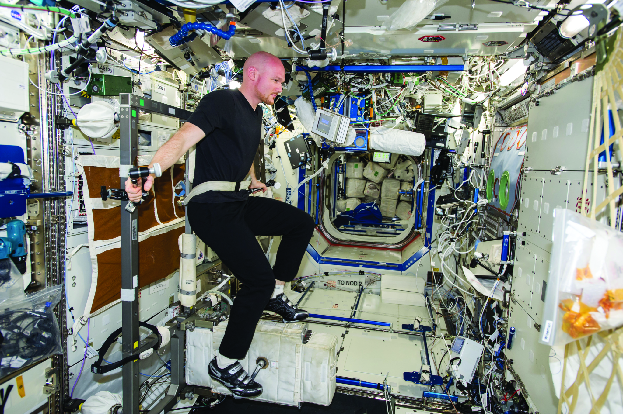 astronaut Alexander Gerst using the exercise bike while on the international space station