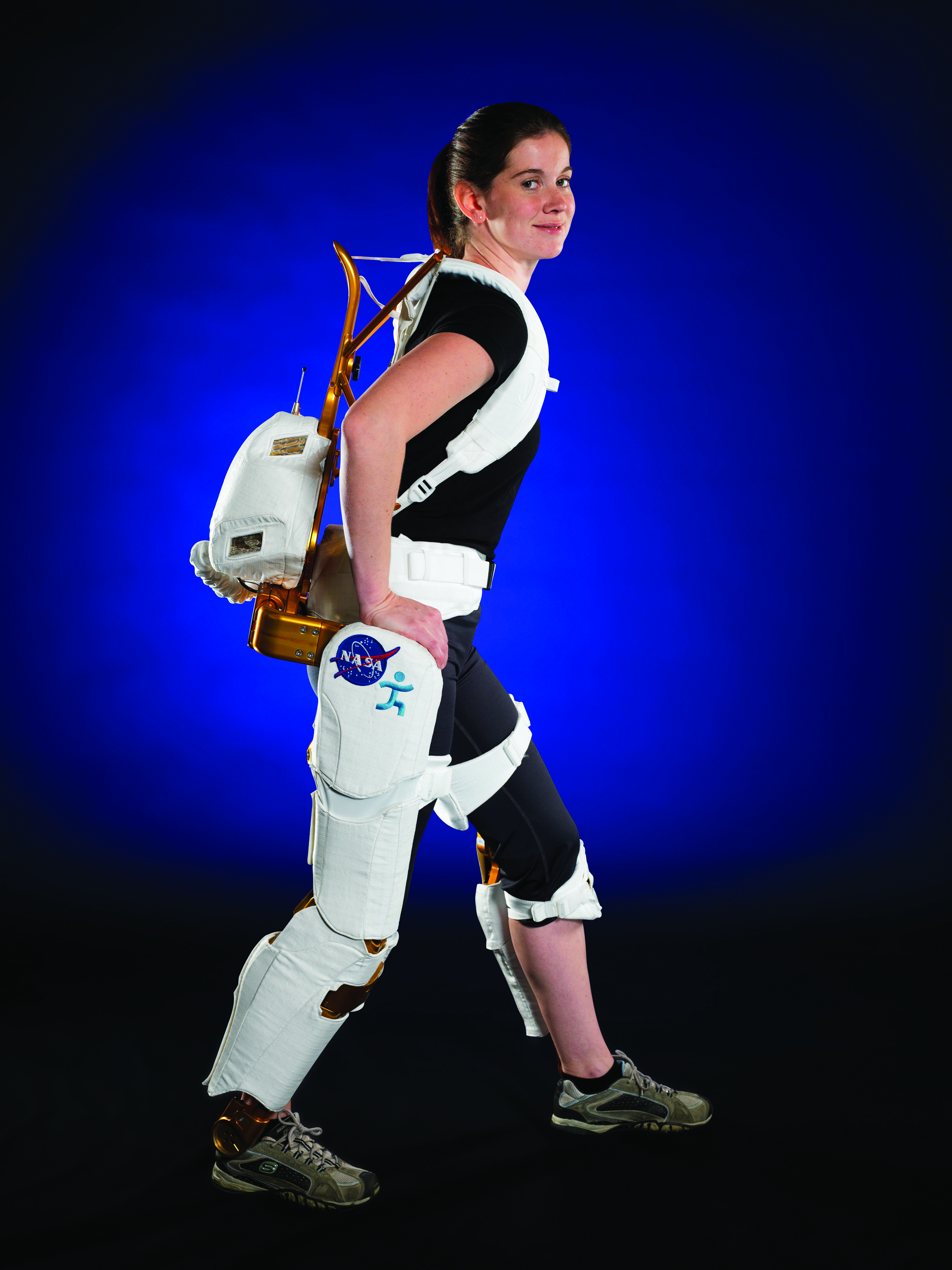 NASA Project Engineer Shelley Rea wears robotic leg harness as demonstration, which is mean for use by human paraplegics in spac