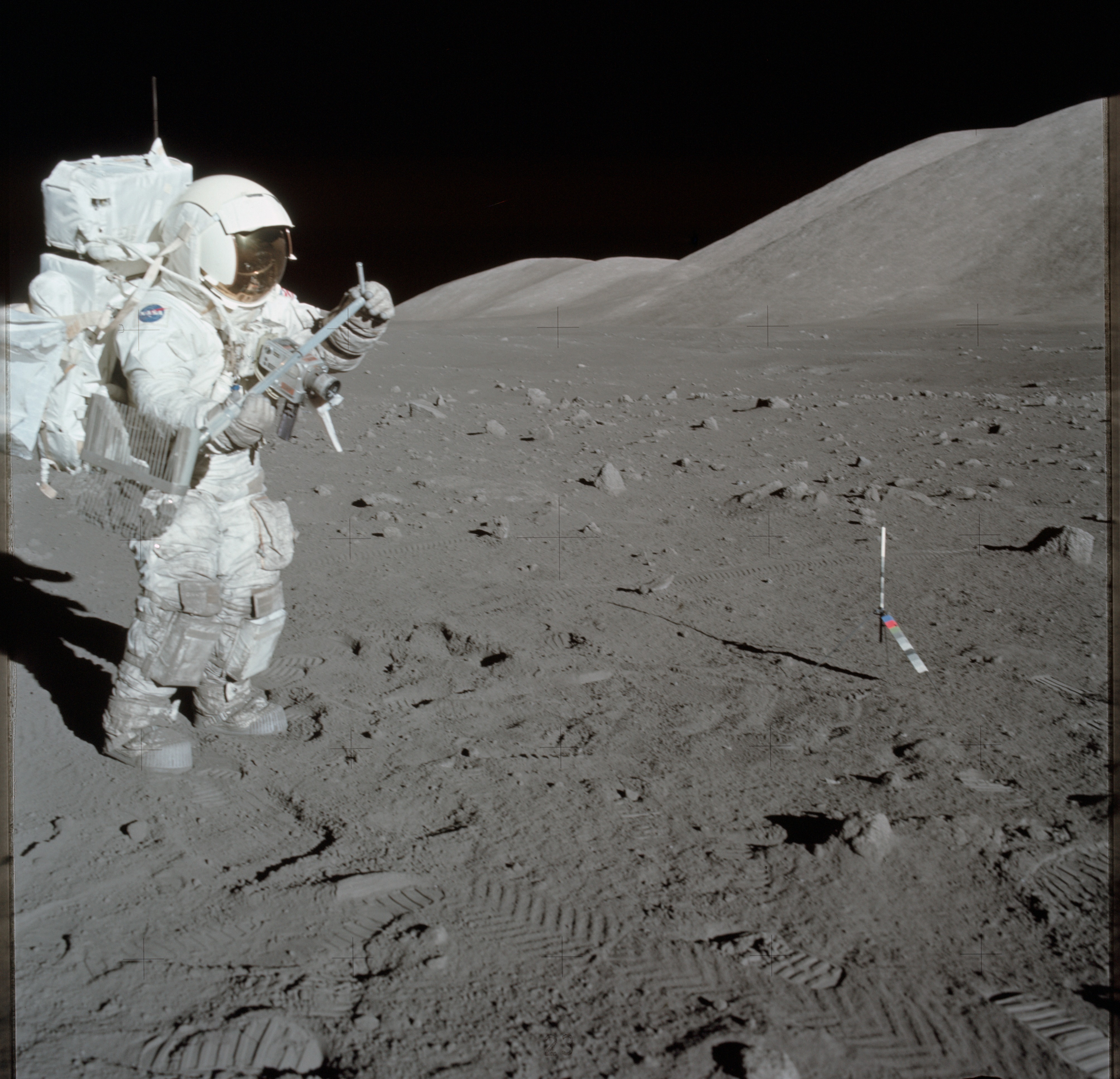 Scientist-astronaut Harrison H. Schmitt collects lunar rake samples