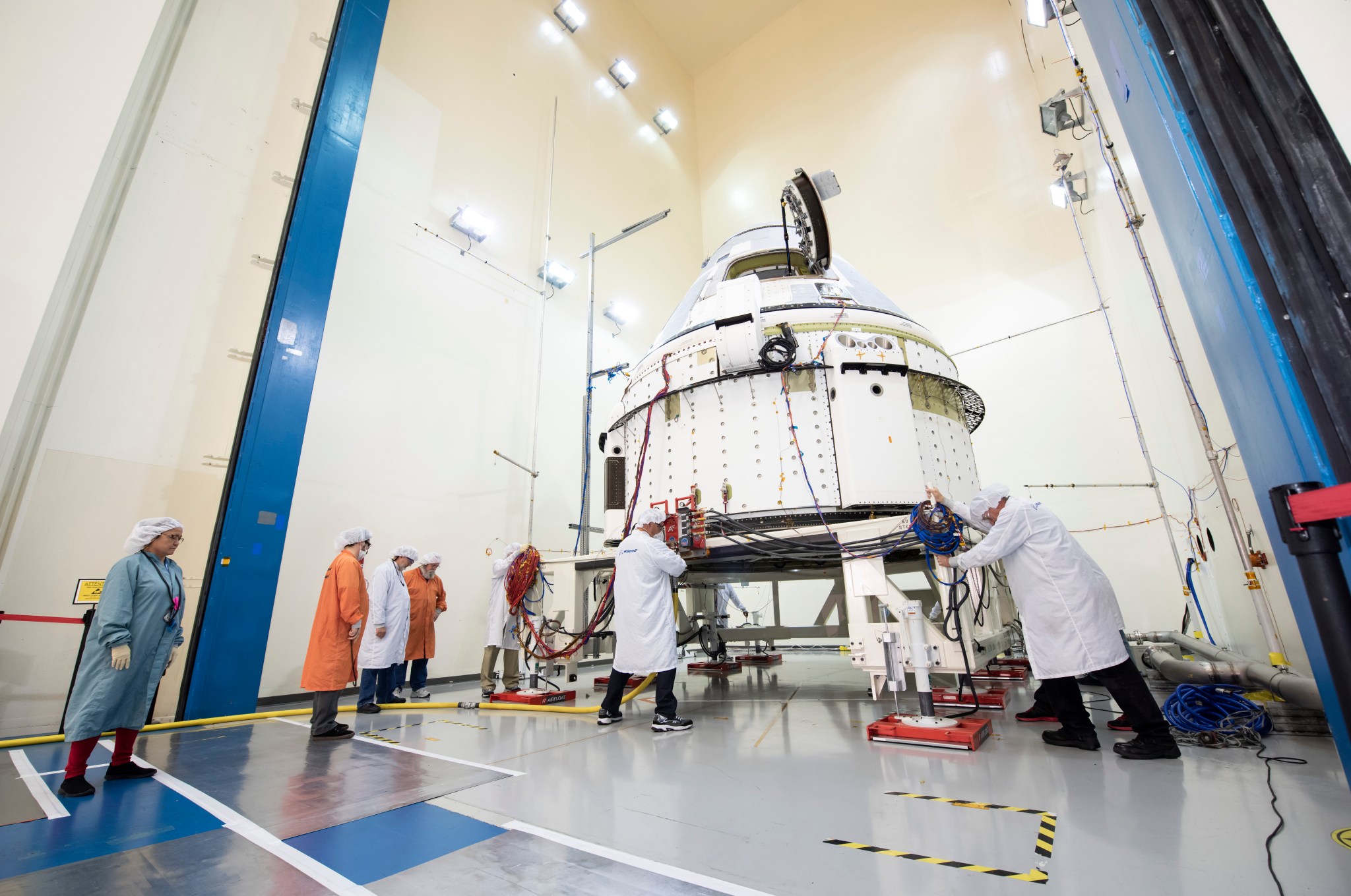 Technicians at Boeing Space Environment Test Facility in El Segundo, California, position Starliner for an acoustics test.